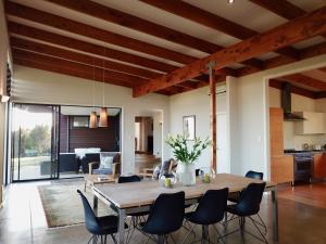 a dining room with a large wooden table and chairs at Te Kahu in Whangarei