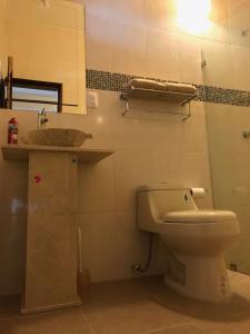 y baño con aseo y lavamanos. en Casa Teotitlán, en Oaxaca City