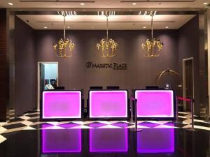 a group of purple chairs in a room with chandeliers at Maxhome @ D'Majestic Place, KL City Centre in Kuala Lumpur