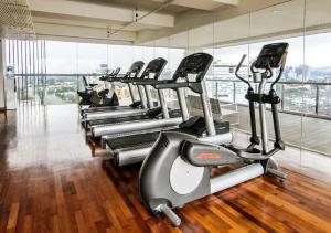 a row of treadmills in a gym at Maxhome @ D'Majestic Place, KL City Centre in Kuala Lumpur