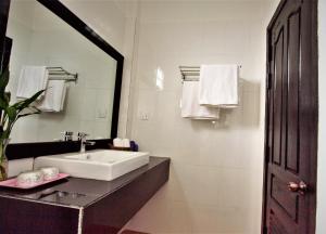 a white bathroom with a sink and a mirror at Sonalong Boutique Village & Resort in Siem Reap +135 photos