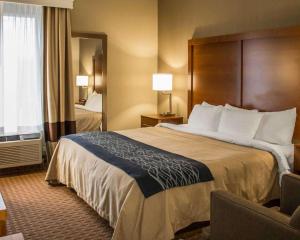 a hotel room with a large bed and a window at Quality Inn in Akron +18 photos
