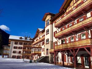 a large building with snow in front of it at Dolomiti Skyview in Carbonin
