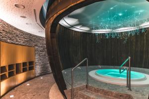 a jacuzzi tub in a building at Das Salvator Iris Porsche Landhotel in Friesach +66 photos