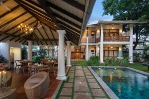 an estate with a swimming pool and a house at Bilin Tree House in Galle