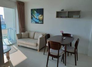 a living room with a table and a couch at Grandblue condominium Room 606 in Mae Pim