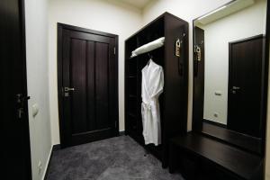 a bathroom with a black door and a mirror at West Hotel in Smolensk