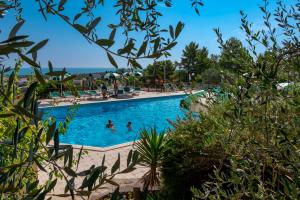 a pool at a resort with people in it at Villaggio Passo Dell'Arciprete in Vieste