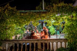a group of people sitting at a table in a park at Villaggio Passo Dell'Arciprete in Vieste