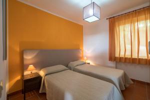 a bedroom with two beds and a window at Villaggio Passo Dell'Arciprete in Vieste