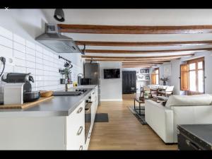 a kitchen and living room with a couch and a table at WeRentVLC - Encantador Loft Casco Antiguo in Valencia