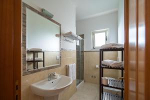 a bathroom with a sink and a mirror at Villaggio Passo Dell'Arciprete in Vieste