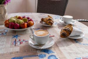 a table with a cup of coffee and a bowl of fruit at Villaggio Passo Dell'Arciprete in Vieste