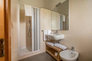 a white bathroom with a sink and a shower at Villaggio Passo Dell'Arciprete in Vieste
