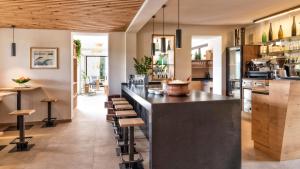 a bar in a restaurant with stools at Die Sonne in Kaltern in Caldaro