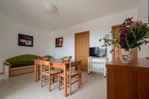 a living room with a table and chairs and a couch at Villaggio Passo Dell'Arciprete in Vieste