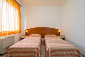 a room with two beds in a room at Villaggio Passo Dell'Arciprete in Vieste