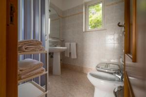 a bathroom with a toilet and a sink at Villaggio Passo Dell'Arciprete in Vieste