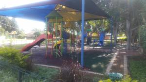 a playground with a slide in a park at The Pearl in Yehud