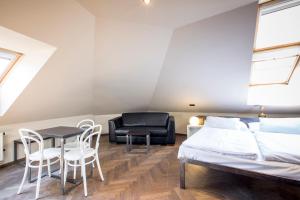 a bedroom with a bed and a table and chairs at Sophie's Hostel in Prague