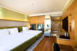 a hotel room with two beds and a television at Baymond Hotel in Busan +50 photos