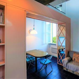 a small dining room with a table and a couch at La Finestra sul Mare in Portovenere