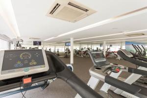 a gym with a treadmill and a simulator at Hotel Presidente Luanda in Luanda