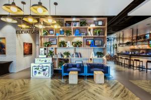 a lobby of a store with blue couches and plants at CAMPANILE PRIME Warszawa Centrum in Warsaw
