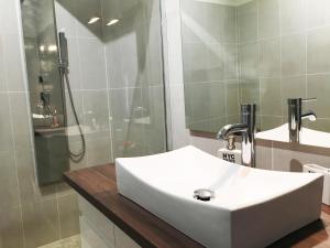 a bathroom with a white sink and a shower at Mélanie Marseille in Marseille