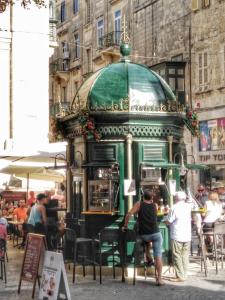 a group of people sitting at an outdoor restaurant at Luciano Valletta Boutique in Valletta