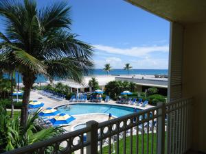 a beach scene with a balcony overlooking the ocean at Delray Sands Resort in Boca Raton