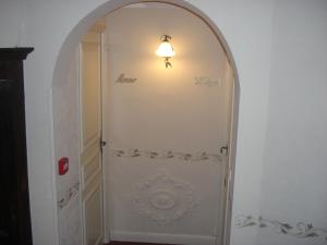 an archway with a light on top of a door at La Marjolaine in Juan-les-Pins