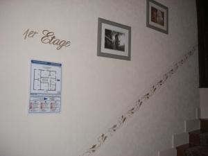 a white staircase with pictures on the wall at La Marjolaine in Juan-les-Pins