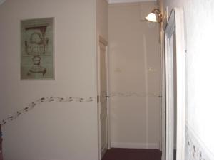 a bathroom with a walk in shower next to a door at La Marjolaine in Juan-les-Pins