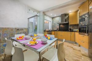 a kitchen with a table with fruit on it at Ca Se Predine - Mediterranean Styled Townhouse in Alcudia