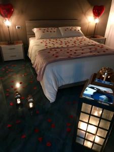 a bedroom with a bed with red flowers on the floor at Dimora nel Benessere in Monopoli