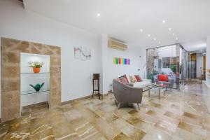 a living room with a couch and a table at Ca Se Predine - Mediterranean Styled Townhouse in Alcudia