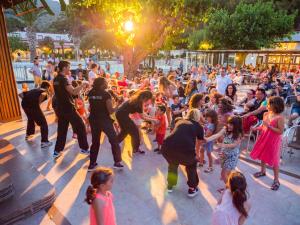 a group of people dancing in front of a crowd at Ciudad De Vacaciones Cala Montjoi in Roses +78 photos