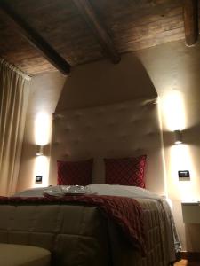 a bedroom with a bed with two lights on it at Hotel Arimannia in Caramanico Terme