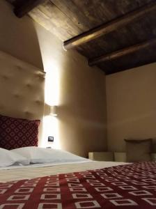 a bedroom with a bed and a light on the ceiling at Hotel Arimannia in Caramanico Terme