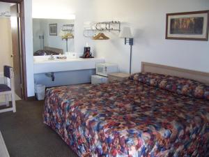 a hotel room with a bed and a sink at A Wyoming Inn in Cody