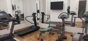 a gym with several exercise bikes and a mirror at Sina Brufani in Perugia