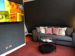 a living room filled with furniture and a couch at Berjaya Eden Park London Hotel in London