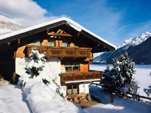 une cabane en rondins dans la neige avec des arbres enneigés dans l'établissement Haus Marco, à Neustift im Stubaital