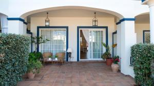 a front porch of a house with a patio at Leo San Bruno in Isla Canela