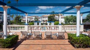 a group of chairs sitting under a gazebo at Leo San Bruno in Isla Canela