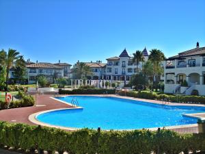 a large swimming pool in front of some houses at Leo San Bruno in Isla Canela