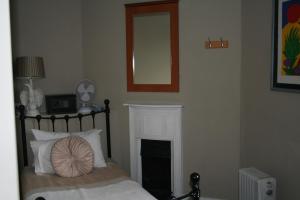 a bedroom with a bed with a fireplace and a mirror at Central Station in London