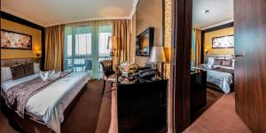 a hotel room with a bed and a desk at Hotel Délibáb in Hajdúszoboszló +69 photos