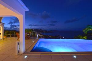a villa with a swimming pool at night at Mystique luxury villa at the heart of the island in Gustavia